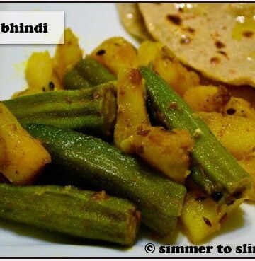 Aloo Bhindi served with roti on a white plate