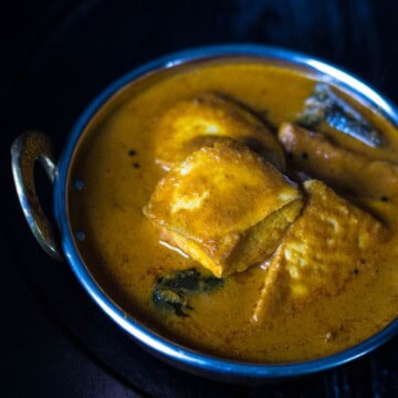 Meen gassi (fish curry) served in a metal bowl