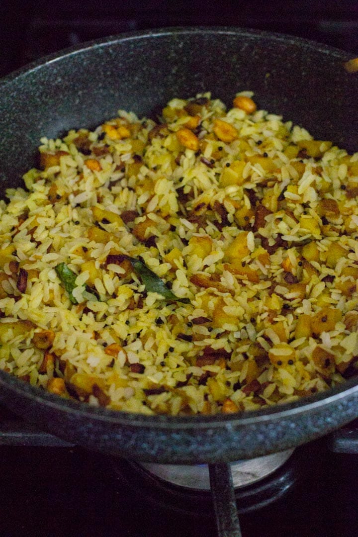 Poha is added to the onion-potato mixture