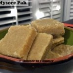 Pieces of Mysore Pak stacked in a green and brown bowl