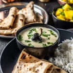Gujarathi kadhi is served along with rice, rotis and a side of lemon