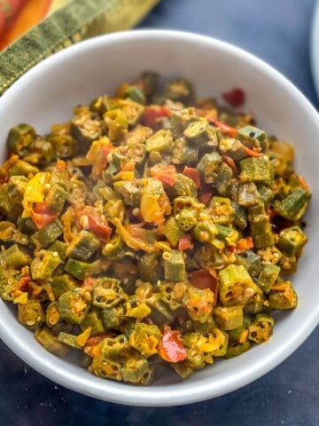 An overhead shot of bhindi masala served in a white bowl