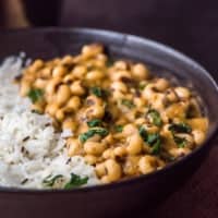 jeera rice served with black chowli in a black bowl