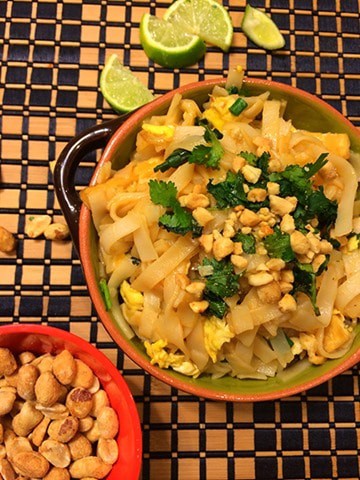 Pad thai served in a brown bowl