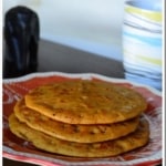 Sweet Cheela stacked in a red and white plate