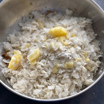 Poha and ghee added in a steel bowl