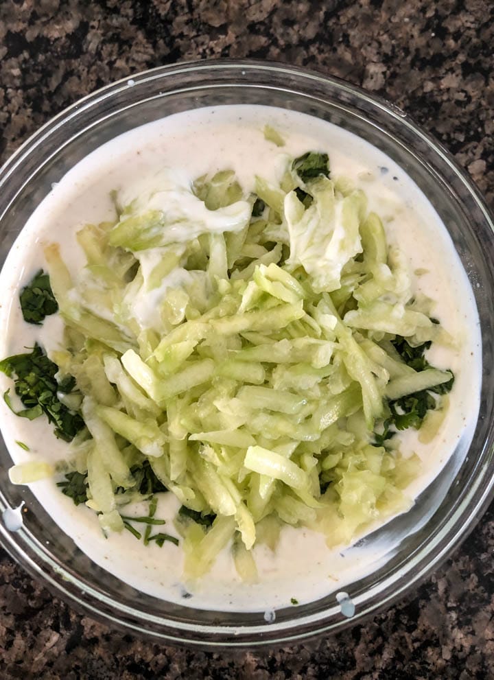 Green chilies, grated cucumber, cilantro are added to yogurt