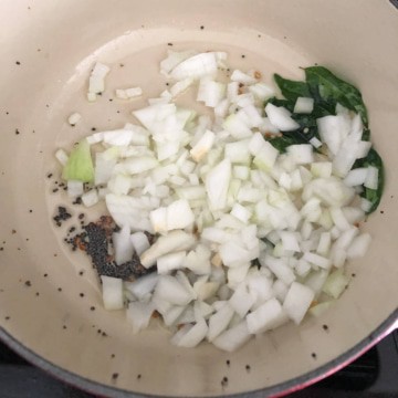Onions being sauteed in a pan