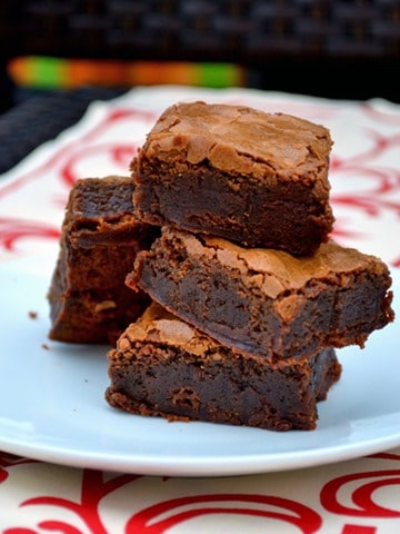 Brownies stacked on a white plate