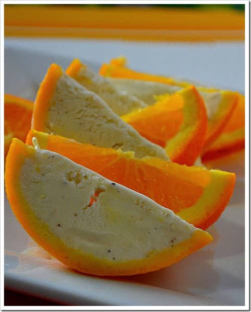 Orange wedge ice cream served on a white plate