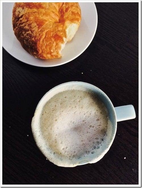 Cappuccino served in a cup with croissant