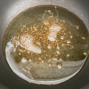 Ghee and Cumin seeds in a wok