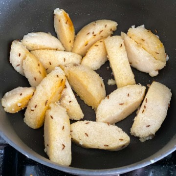 Golden brown idlis in a wok