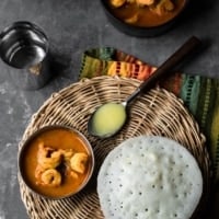 Kappa rutti served with shrimp gassi over a woven trivet