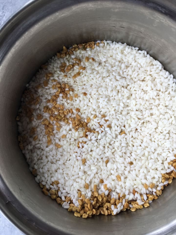 Drained Rice and methi seeds in a bowl 