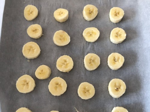 Bite-sized bananas placed on parchment paper