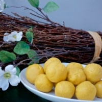 Besan laddoos stacked on a white plate