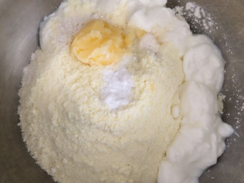 Dough ingredients before mixing, in a silver bowl.