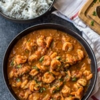 Prawns balchao served in a black bowl with a side of rice