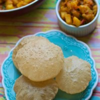 An overhead shot of pooris served with Aloo sabzi (Potato curry)