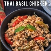 The words 20 Minute Thai Basil Chicken at the top with a black bowl of thai basil chicken topped with bell peppers and basil.
