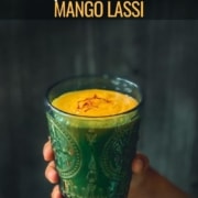 A hand holding mango lassi