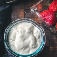 Creamy yogurt with strawberries on the side