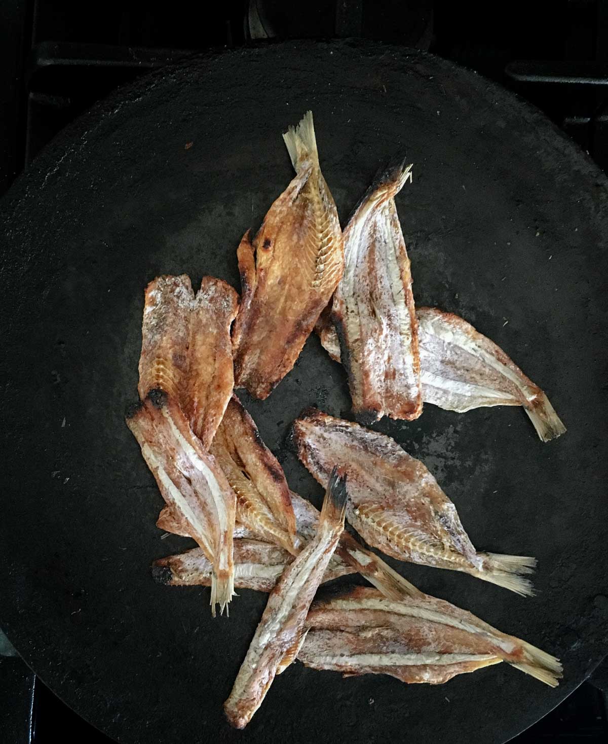 died fish in a cast-iron pan