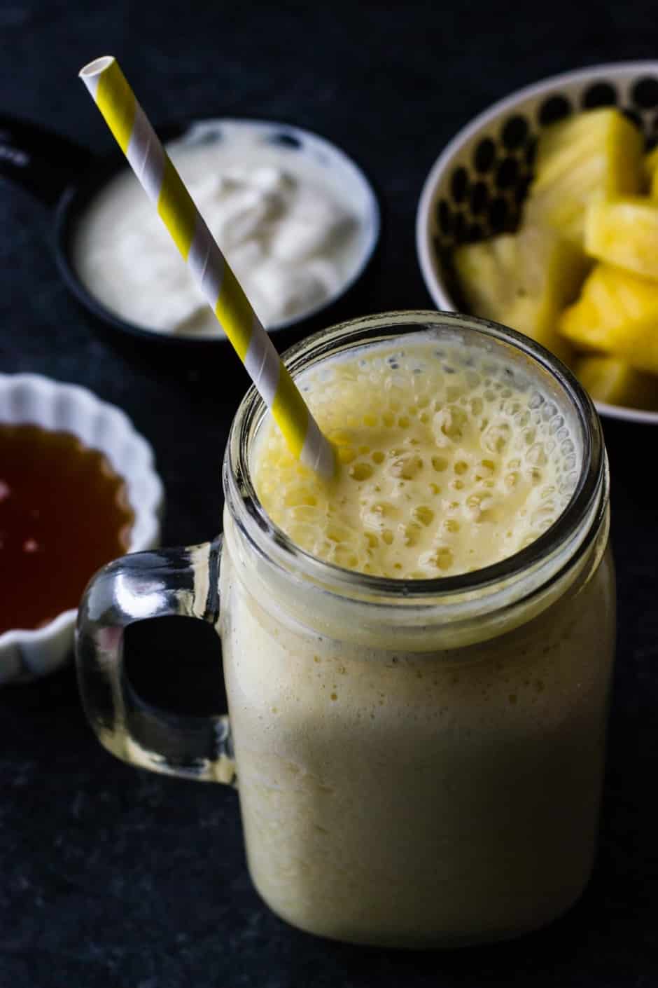 Pineapple orange smoothie served in a ball jar
