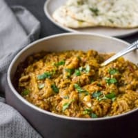 Bhaingan bharta served in a brown and white bowl served with naan