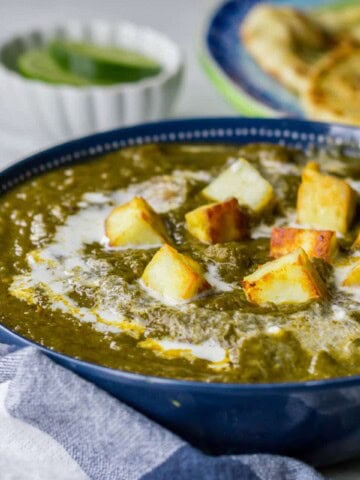 Palak paneer served in a blue bowl