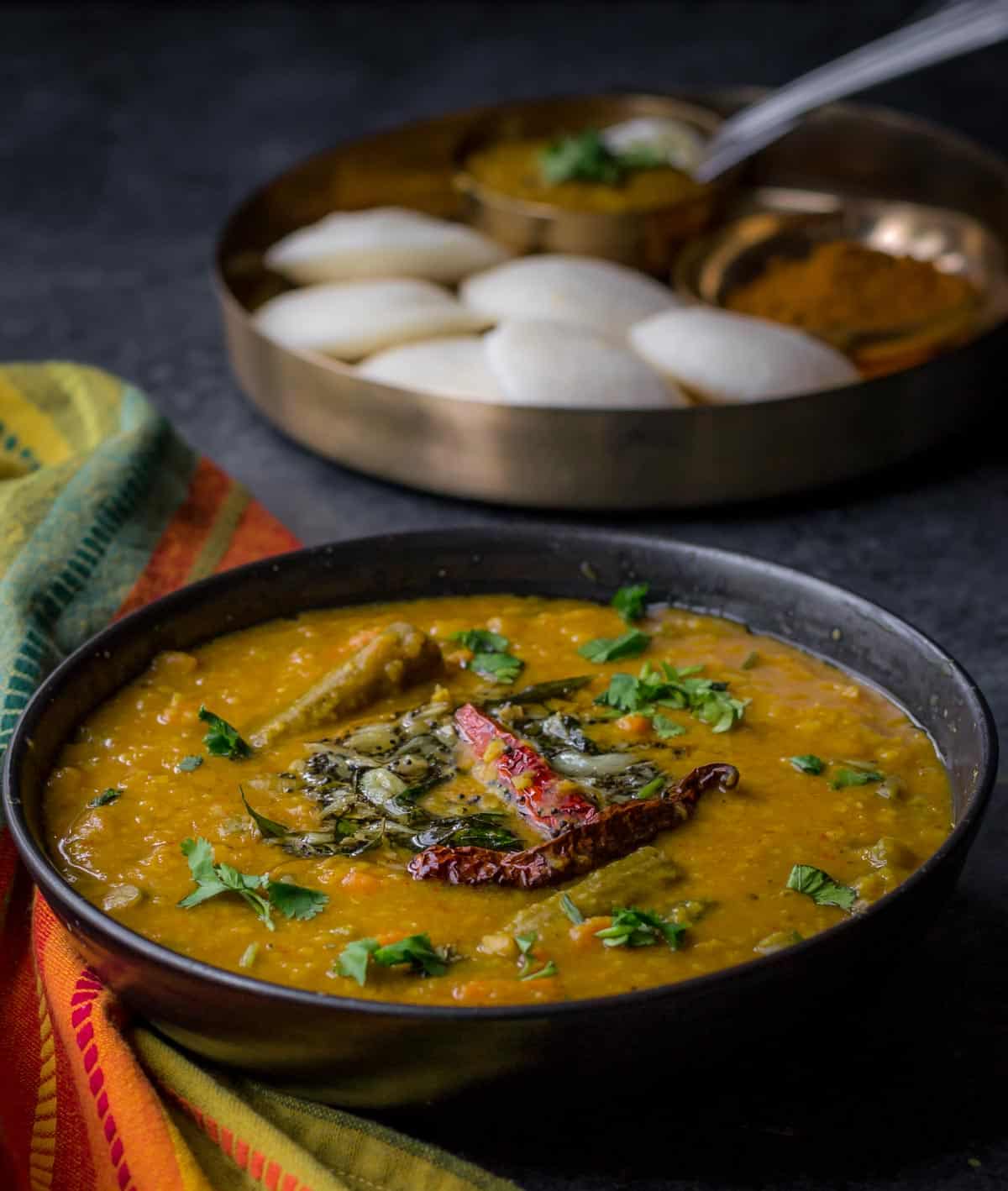 Sambar or Sambhar is a tangy and mildly spicy lentil-vegetable stew from the southern part of India. It is a staple in most South Indian homes and is served alongside idlis or dosas for breakfast or with rice for lunch/dinner.