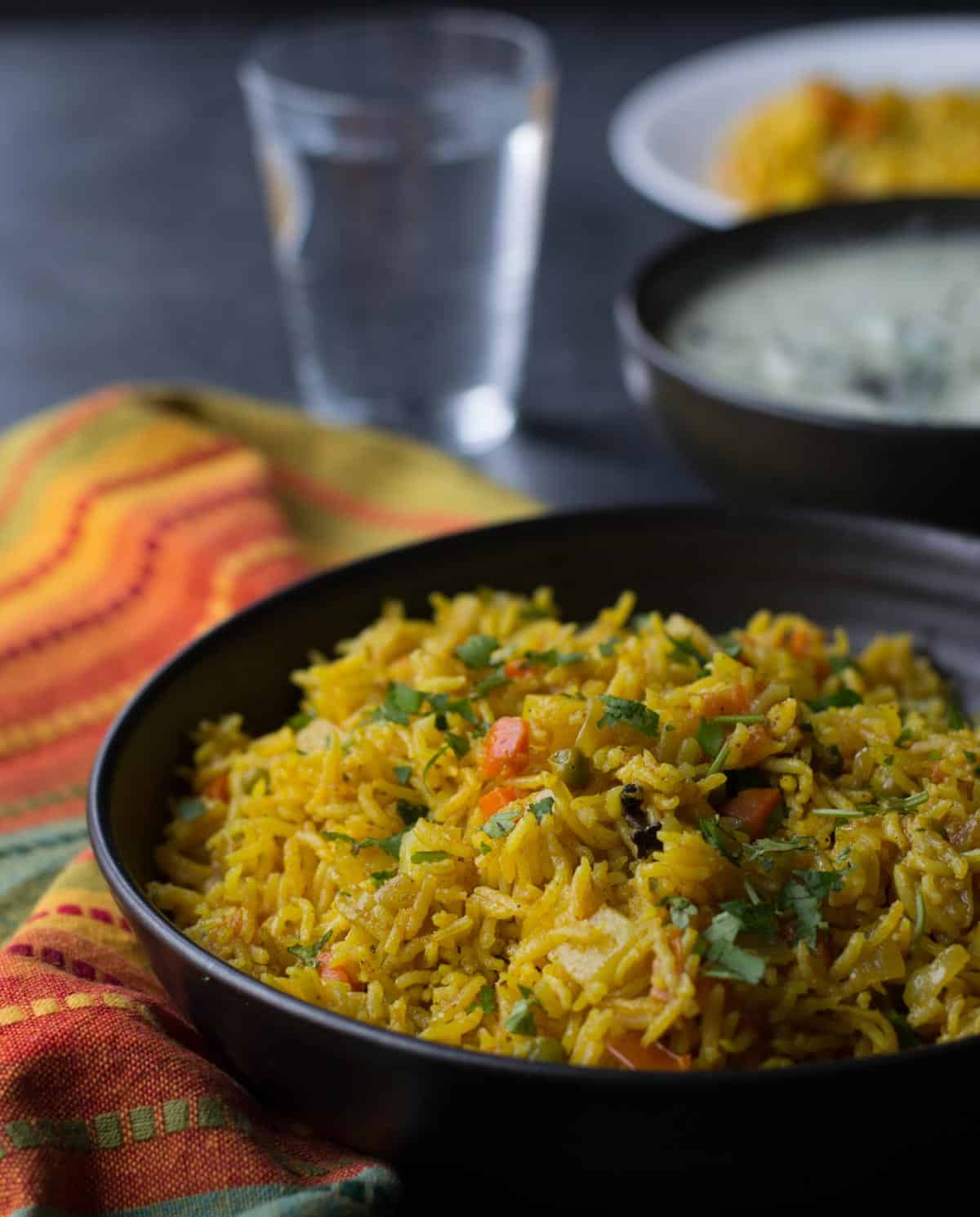 Veg biryani in a black bowl