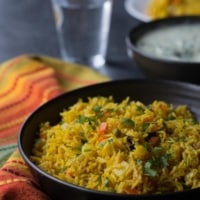 Veg biryani in a black bowl