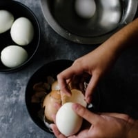 a person peeling eggs