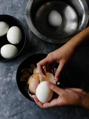 a person peeling eggs