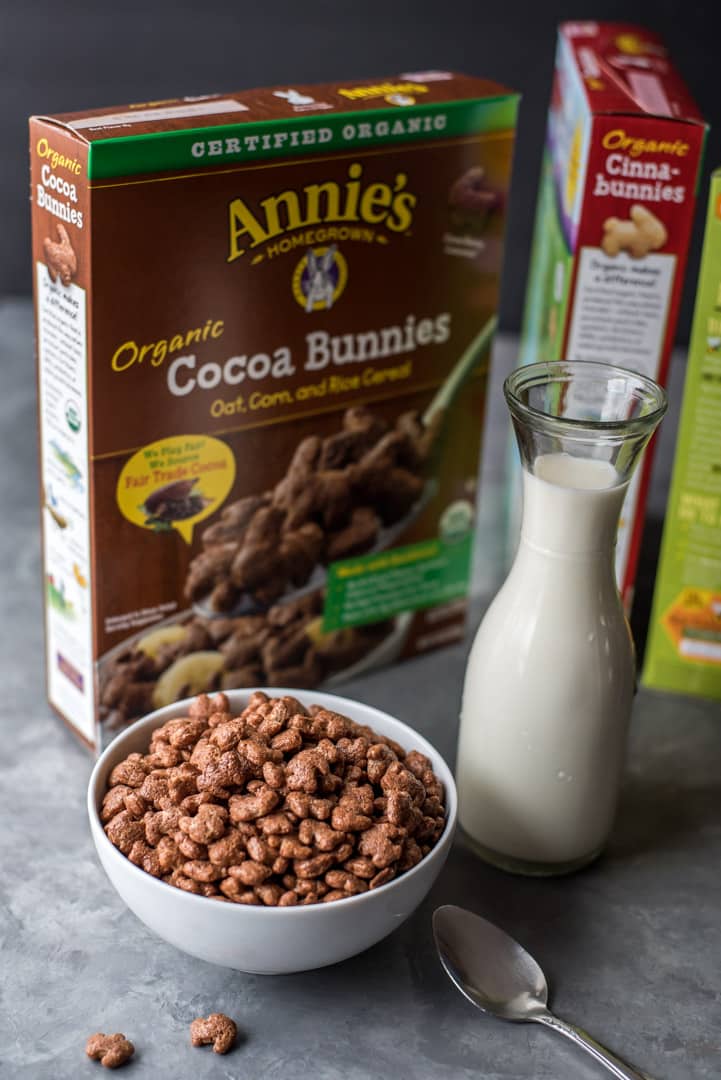 Easy snack ideas - featured in this picture is a bowl of Annie's organic cocoa bunnies in a white bowl along with a jar of milk and boxes of Annie's organic cocoa bunnies cereal
