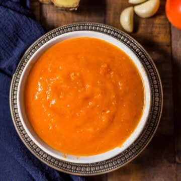 Overhead shot of Onion tomato masala served in a white bowl