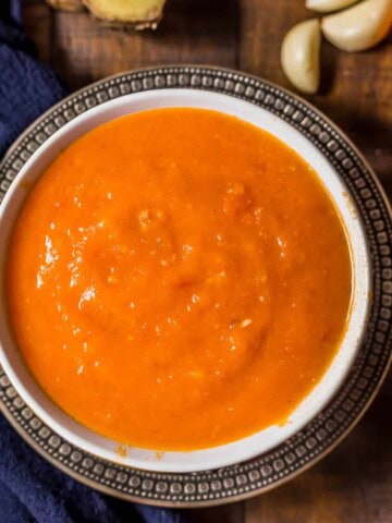 Overhead shot of Onion tomato masala served in a white bowl
