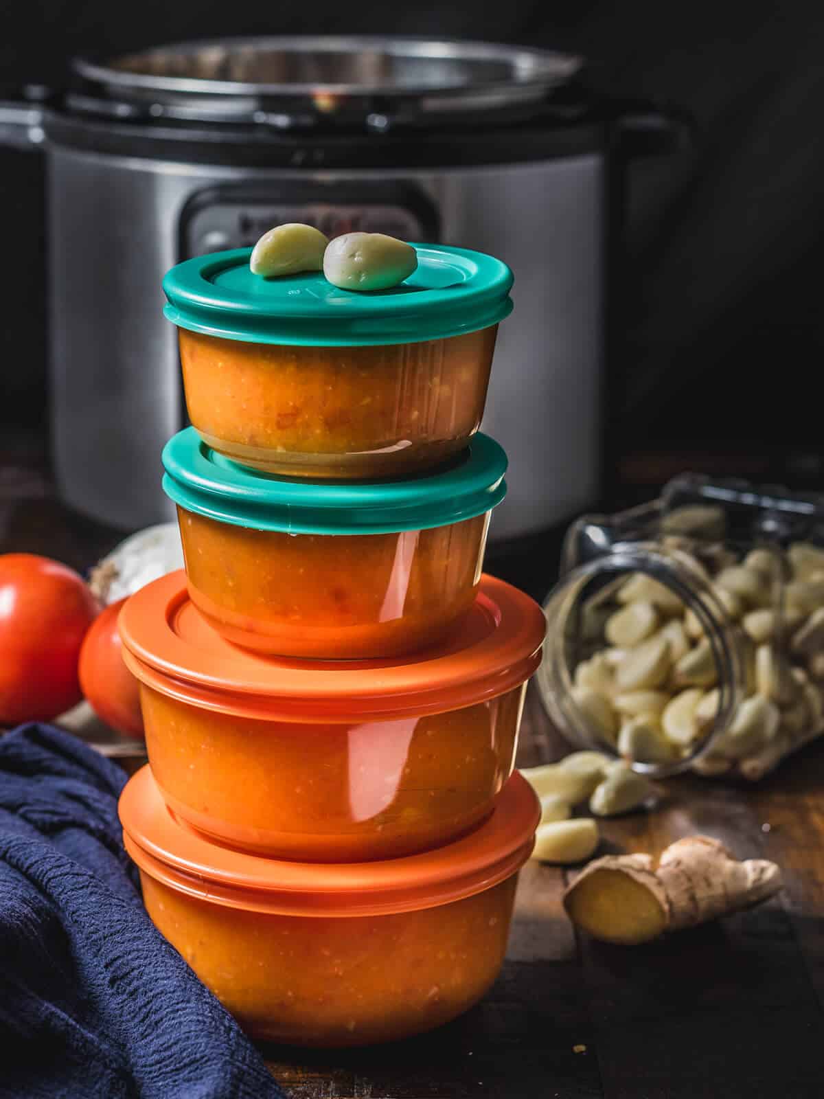 Onion tomato masala (curry sauce) stored in pyrex containers and stacked one top of the other