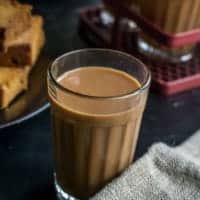 Ginger tea in a glass served with toast