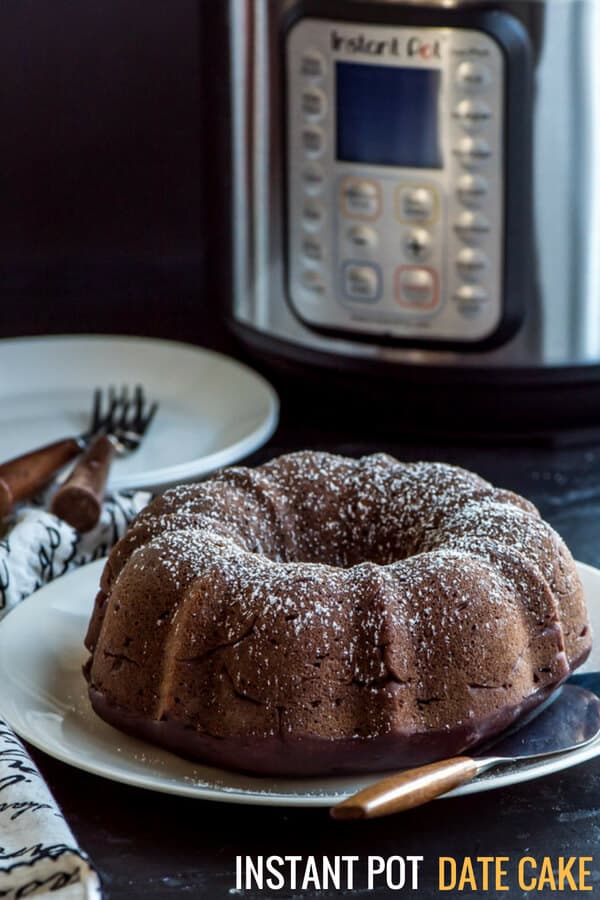 Date cake on white plate with Instant Pot in the background