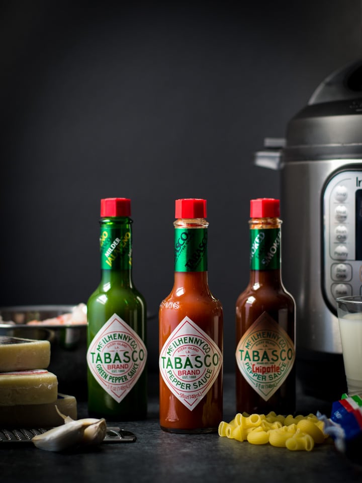 TABASCO sauce bottles are shown in 3 different flavors along with the ingredients to make mac and cheese and an Instant Pot