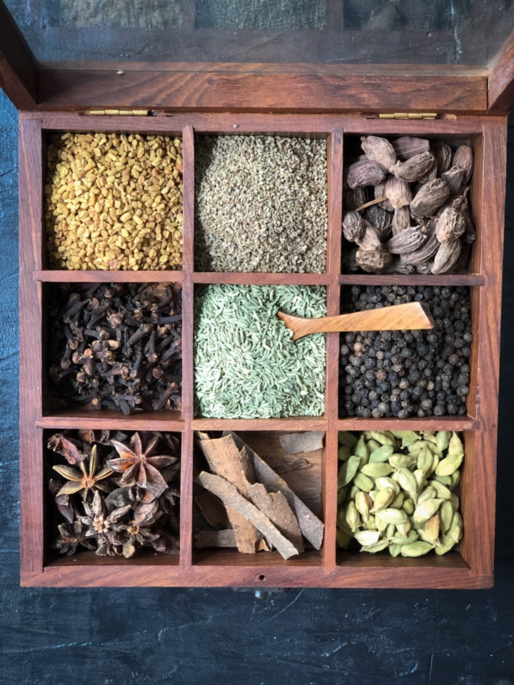 A wooden spice box with 9 compartments