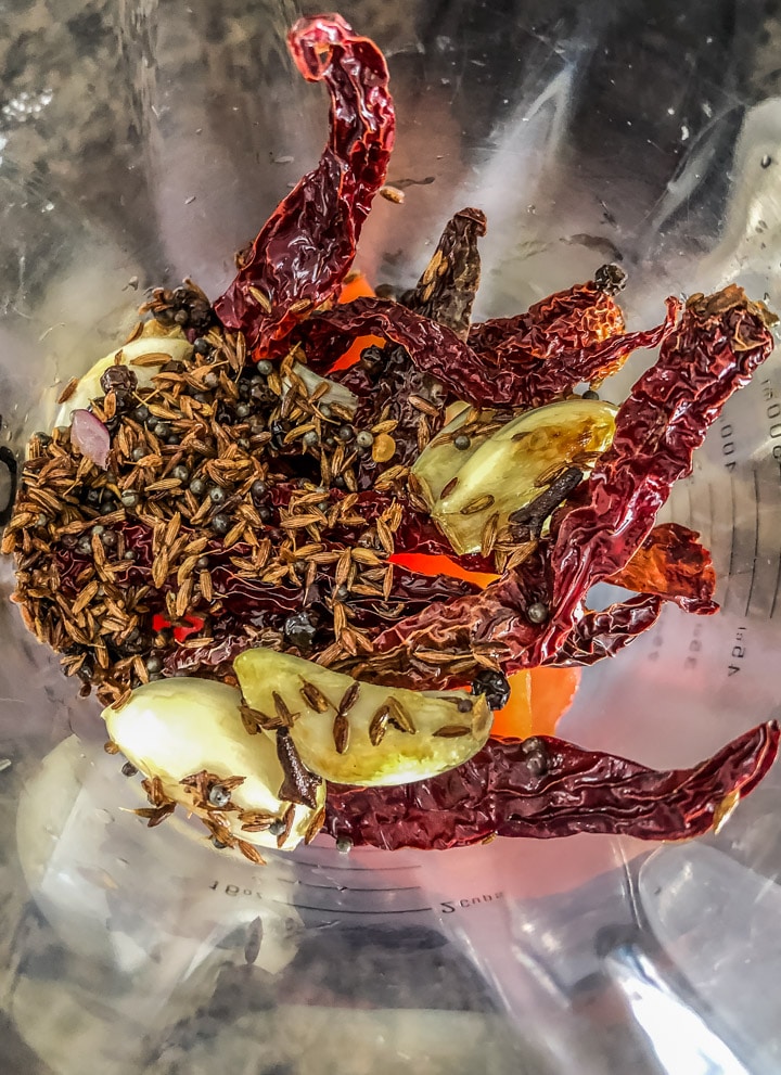 Garlic cloves, red chillies, cumin and mustard seeds in a blender
