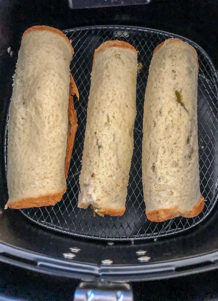 Rolled bread slices in an air-fryer basket