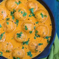 Malai Kofta served in a black bowl