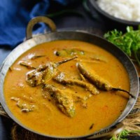 An overhead shot of Mirchi ka salan in a metal kadhai