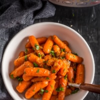 An overhead shot of honey glazed carrots served in a white bowl