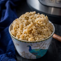 Brown rice served in a white bowl with Instant Pot on the side